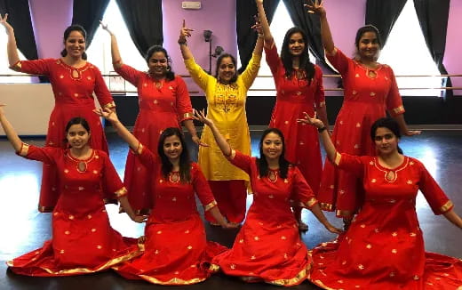 a group of people in red dresses