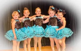 a group of girls in dresses