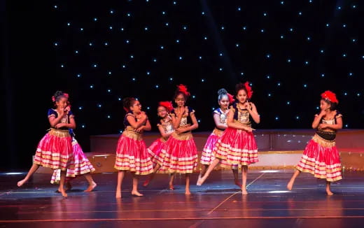 a group of women dancing on a stage