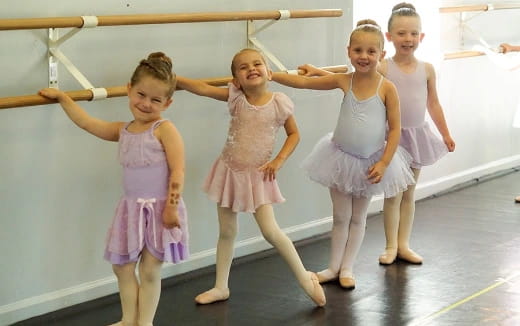 a group of girls in dresses