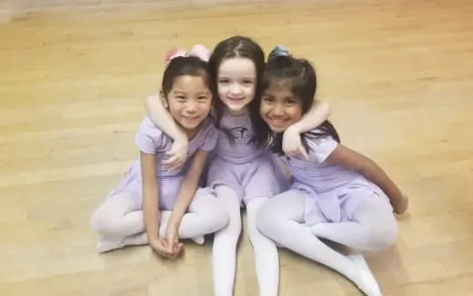 a group of girls sitting on the floor