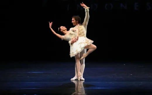 a man and woman dancing on a stage