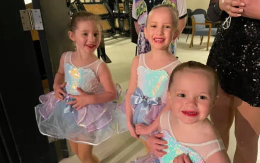 a group of girls in dresses