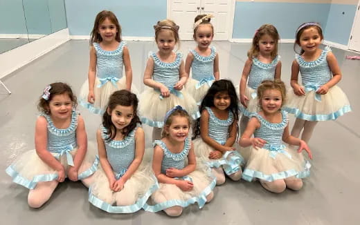 a group of girls in white dresses