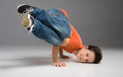 a boy doing a handstand