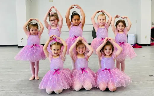 a group of girls in dresses
