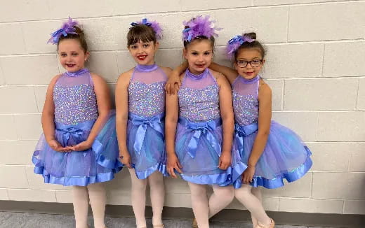 a group of girls in dresses