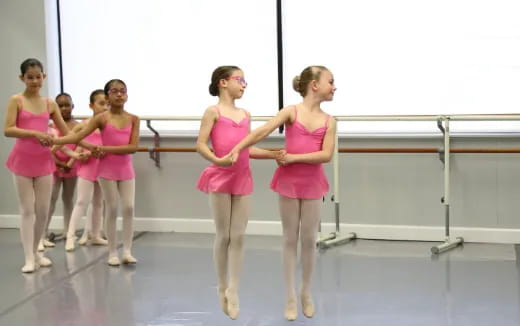 a group of women in pink dresses