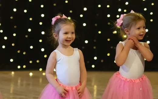 two girls wearing dresses and posing for the camera