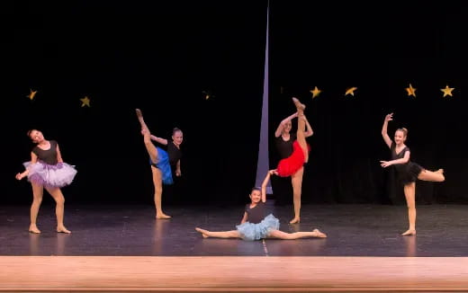a group of people dancing on a stage