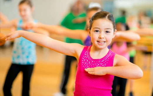 a young girl running with her arms out