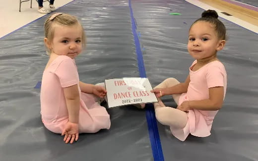 two babies sitting on the floor