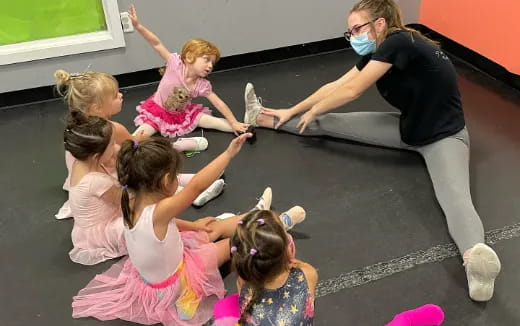 a group of children playing with a person