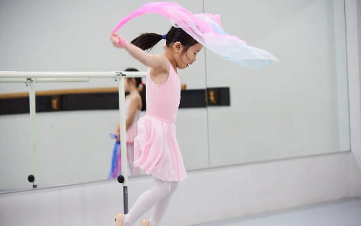 a woman in a pink dress holding an umbrella