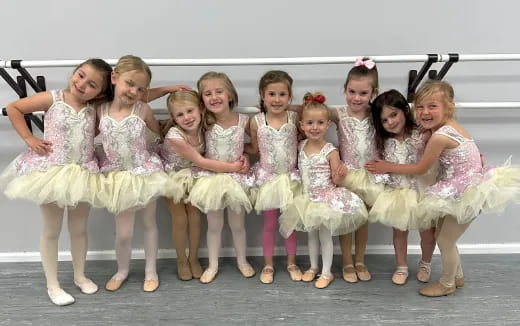 a group of girls in white dresses