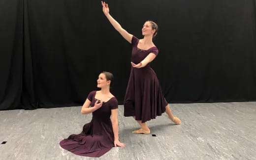 two women in dresses dancing