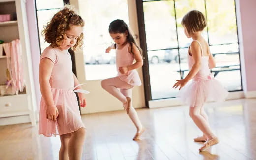 a group of girls in dresses running