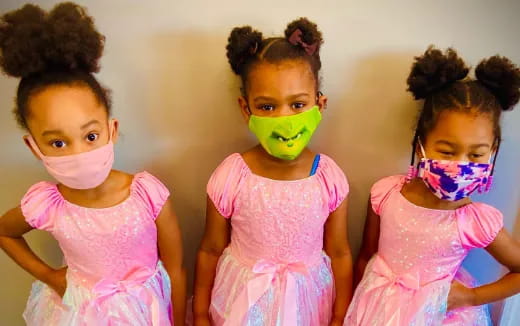 a group of girls wearing pink dresses