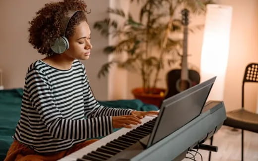 a woman playing a piano