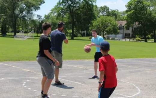 a group of people playing basketball