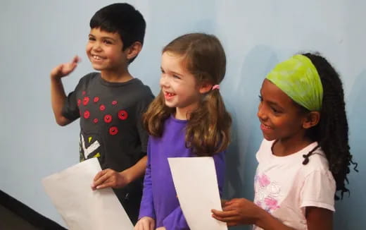 a group of children holding papers