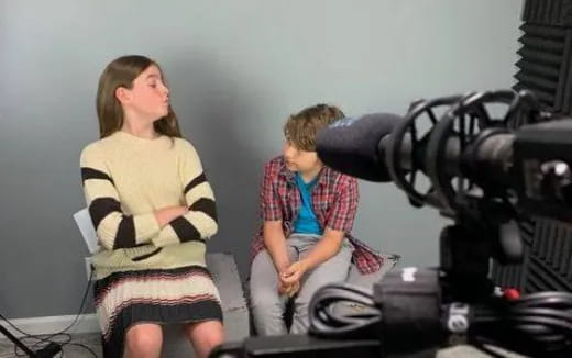 a woman and a man sitting on a machine