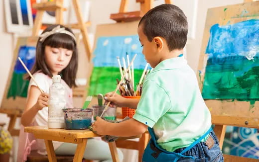 a young boy and girl painting