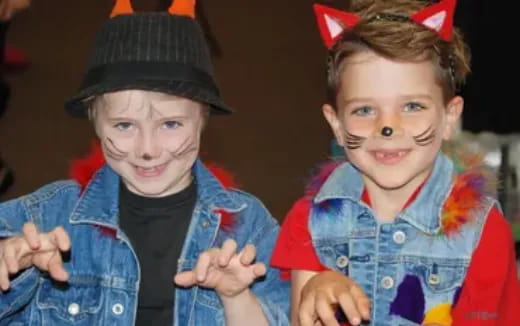 a couple of children wearing clothing