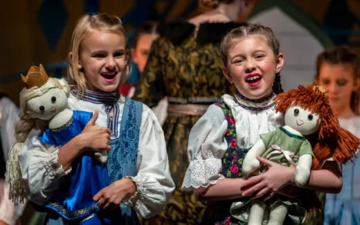 a group of people holding stuffed animals