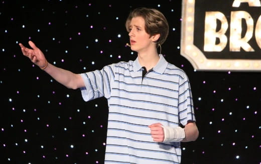 a man standing in front of a large crowd
