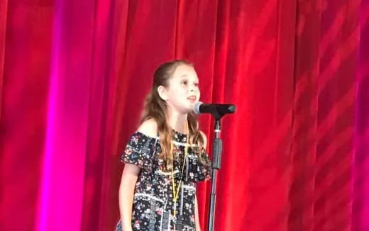 a person singing into a microphone