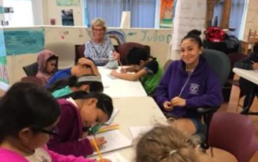 a group of people sitting in a classroom