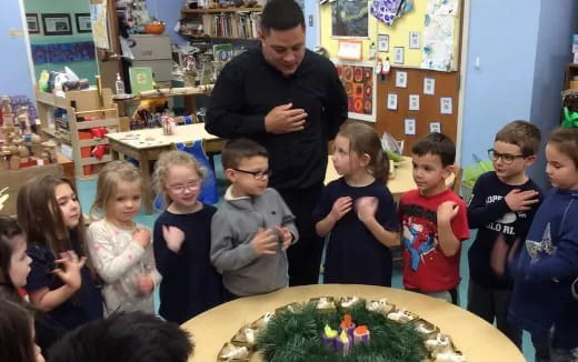 a group of children standing in a classroom