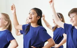 a group of girls in blue shirts