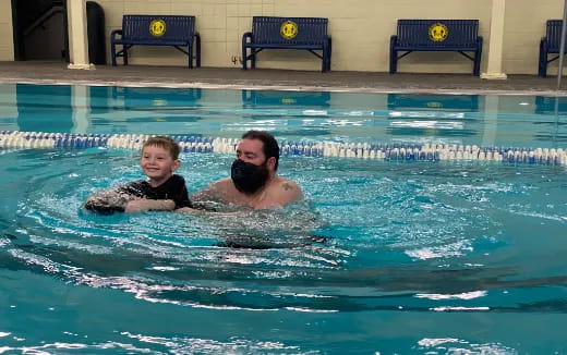 a man and a child in a pool