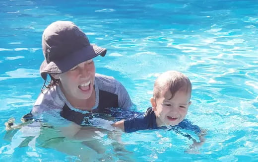a person and a baby in a pool