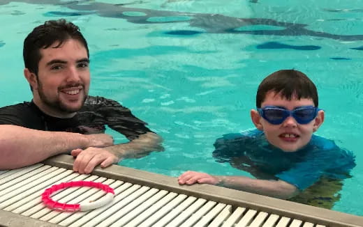 a man and a boy in a pool