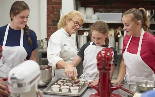 a group of women in a kitchen