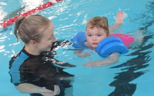 a person and a child in a pool