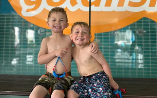 two boys in swimsuits