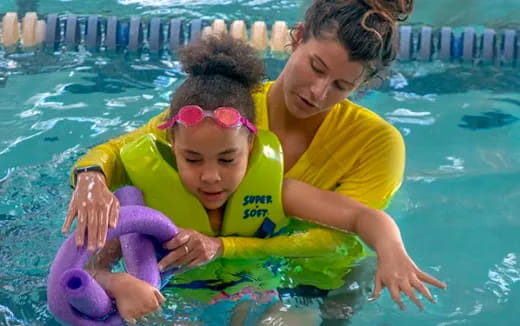 a person and a child in a pool