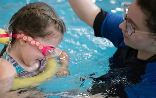 a person and a child in a pool