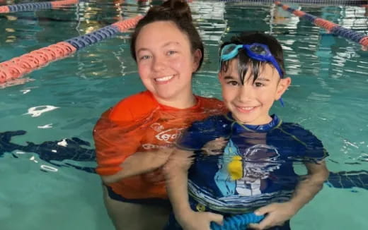 a person and a boy in a pool