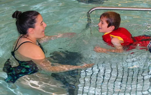 a person and a child in a pool