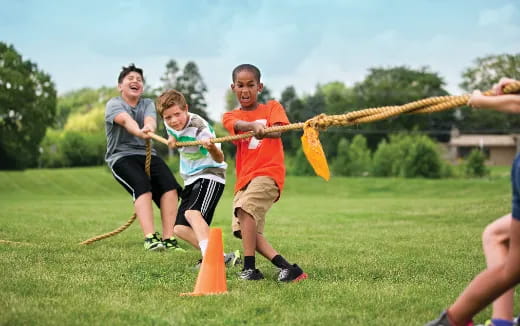a group of people playing with sticks