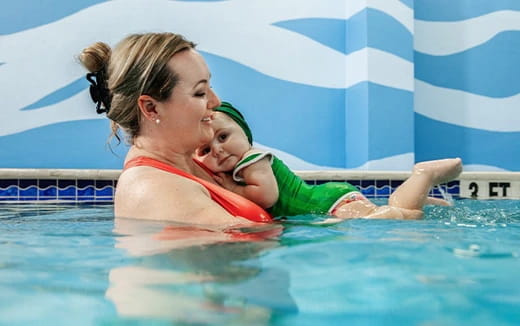 a woman and a child in a pool