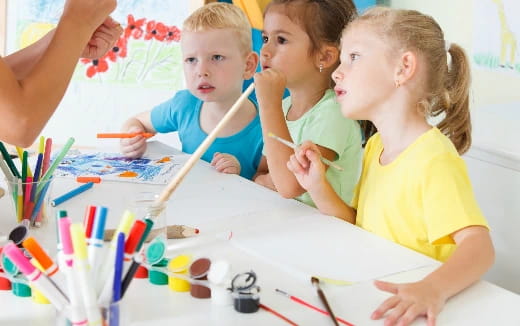 a group of children painting