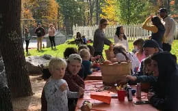 a group of people sitting at a table outside