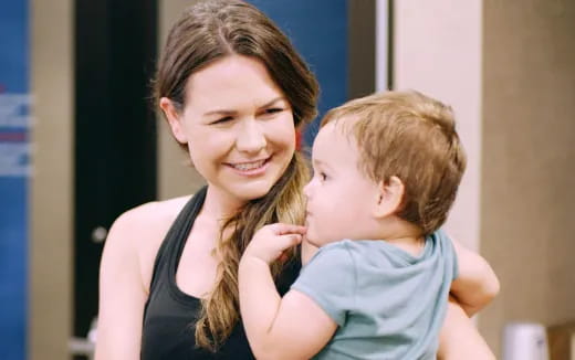 a woman holding a baby