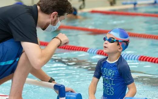 a man and a boy in a pool